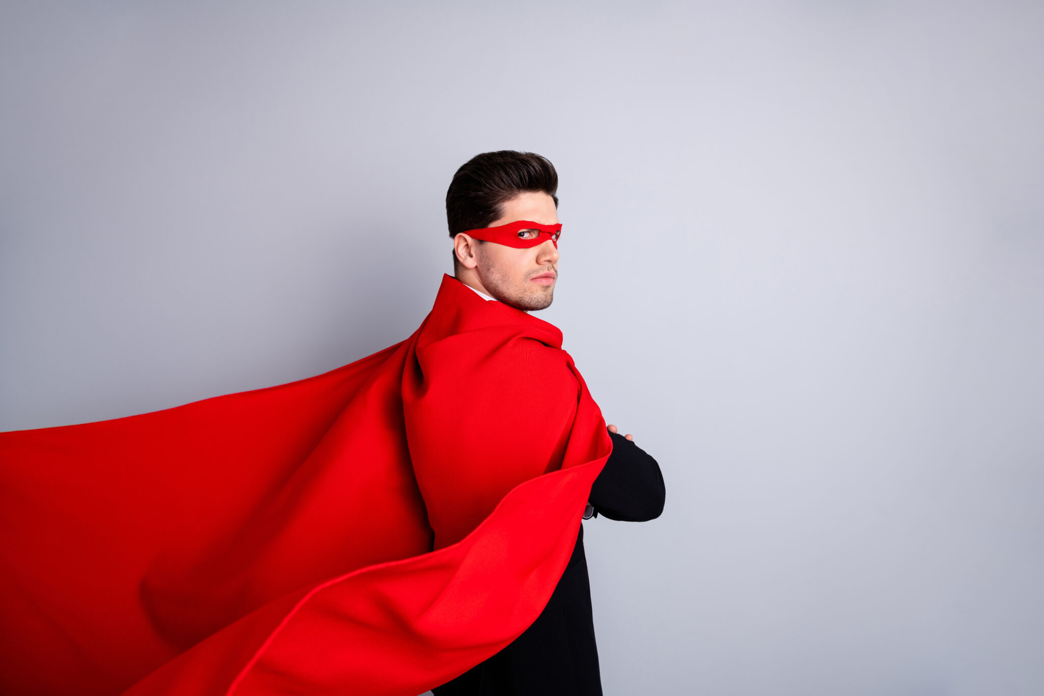 Close up side profile photo adventurous rigorous facial expression he him his man threaten use superpower wear red long cloak raised wind safety protection human race concept isolated grey background