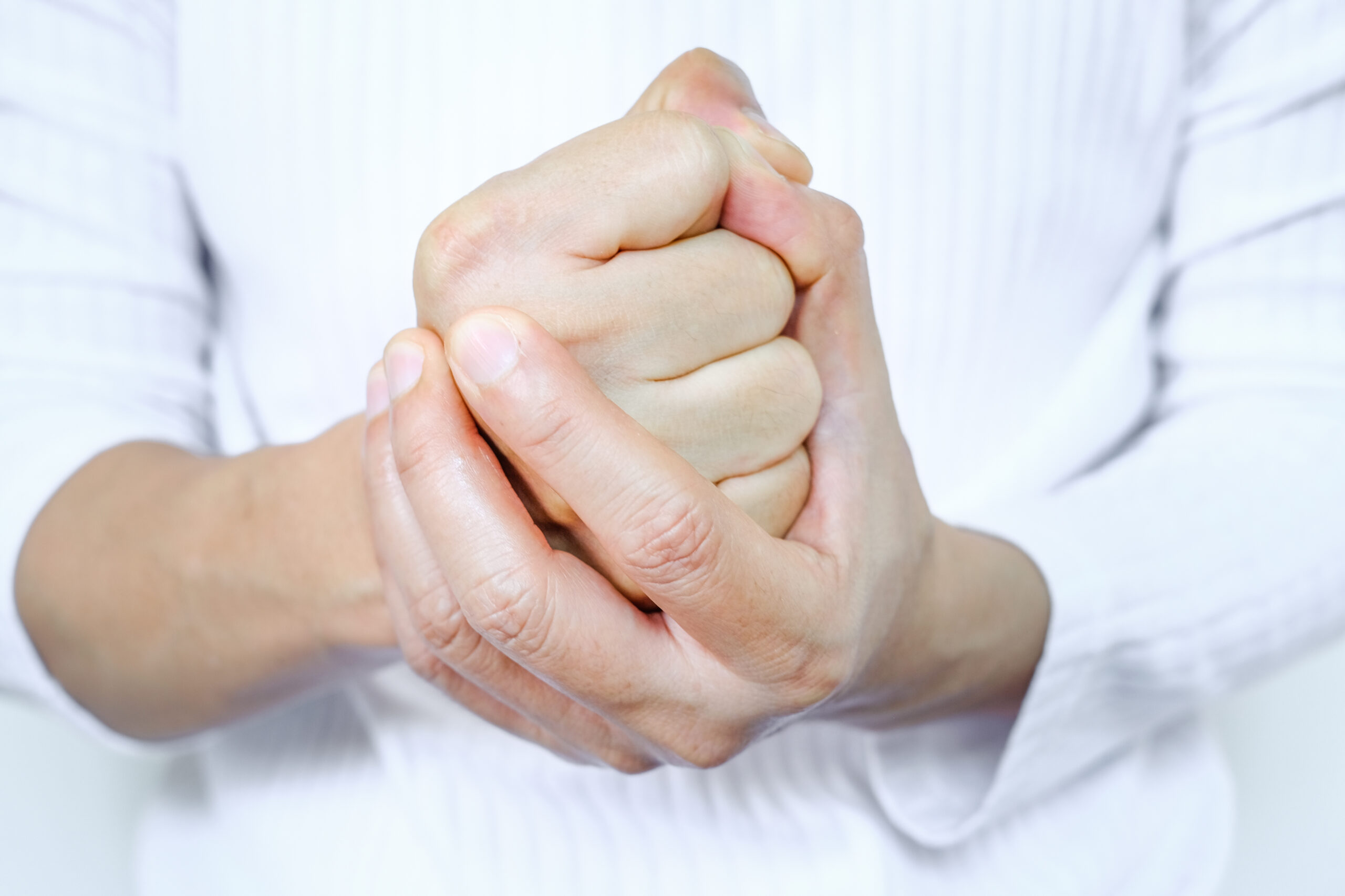 The man clenched his fists, exhibiting stressful and angry behavior from work. feeling of dissatisfaction Medical concepts and emotional regulation